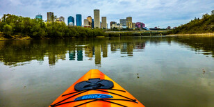Kayak with Edmonton skyline in the distance.