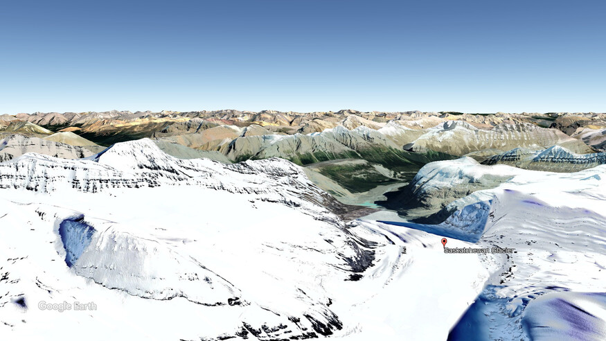 Aerial image has a marker for the Saskatchewan Glacier with other mountains in the background.