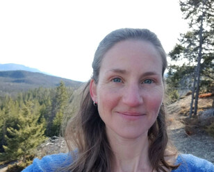 Photo of woman smiling outdoors.